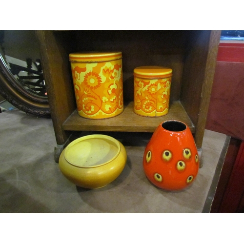 4014 - A 1960's set of three graduated storage containers, a German red glazed speckled vase and a Bretby y... 