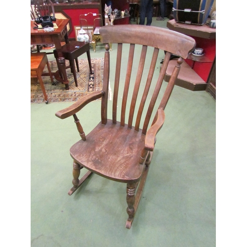 4016 - A Victorian elm seated and lathe back rocking chair  (R)    £60