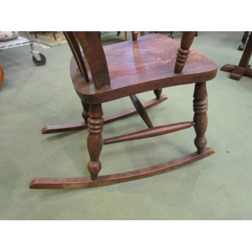 4016 - A Victorian elm seated and lathe back rocking chair  (R)    £60