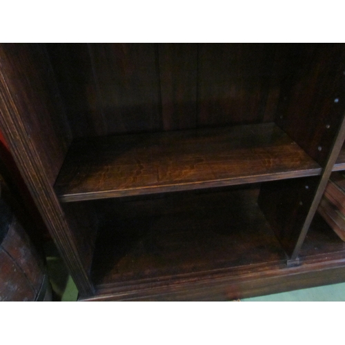 4024 - Circa 1900 an oak side by side bookshelf the raised back over six height adjustable shelves on a pli... 