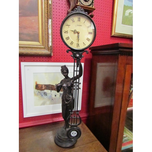 4032 - A modern Juliana figural pendulum clock and a modern Dutch wall clock surmounted by a figure holding... 