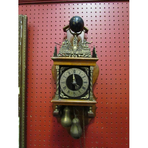 4032 - A modern Juliana figural pendulum clock and a modern Dutch wall clock surmounted by a figure holding... 