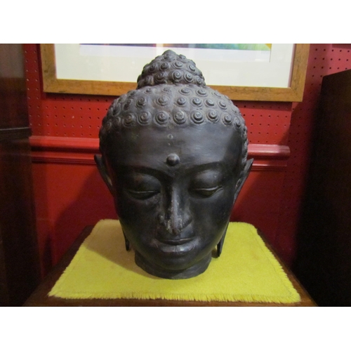 4063 - A cast metal Buddha head, 32cm