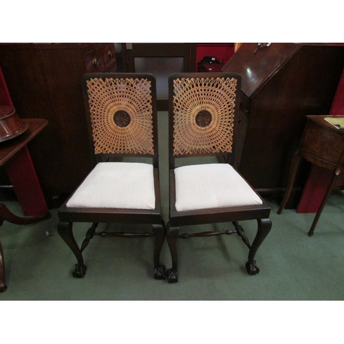 4075 - A pair of cane back chairs on ball and claw feet with 