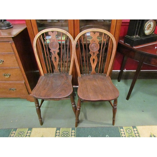 4081 - A matching pair of elm wheel/spindle back kitchen chairs