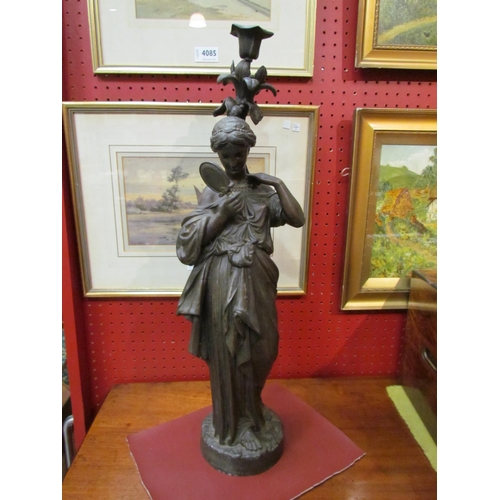 4088 - A spelter figural candle holder of a maiden in Grecian dress with mirror, 56cm tall