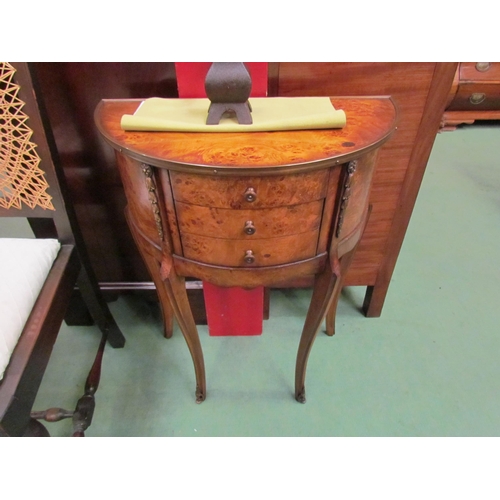 4111 - A French 19th Century style burr walnut and brass demi-lune hall table with three drawers over cabri... 