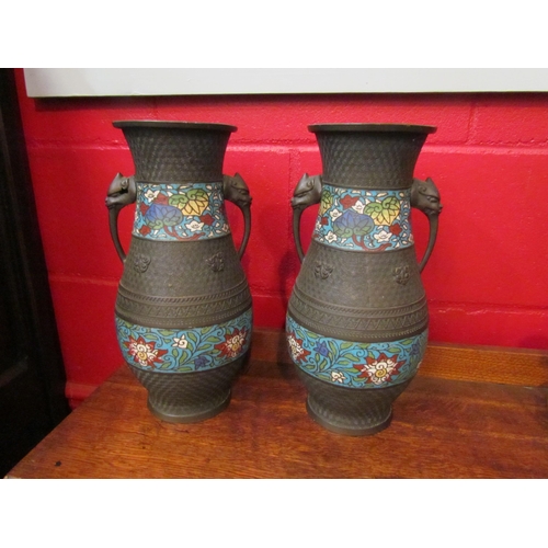 4146 - A pair of metal vases with decorative impressed marks and cloisonne enamel bands, twin mythical crea... 