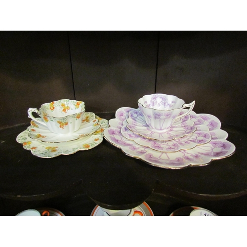 4151 - A Foley china Art Nouveau quattro cup and saucer set with mauve floral design and an earlier trio (2... 