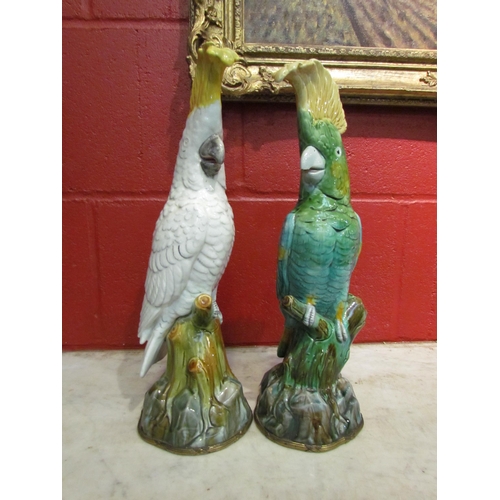 4159 - A pair of Mintons majolica cockatoo figures, one in white with yellow crest, the other in green with... 