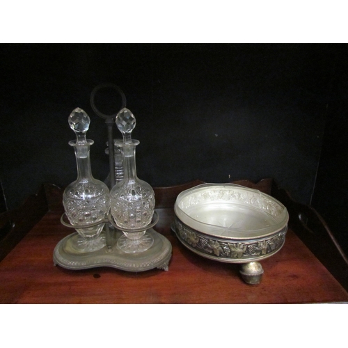 4162 - A tantualus stand with three associated decanters and dish with grape and vine border (2)