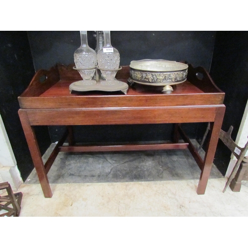 4163 - A George III revival mahogany butlers tray on stand occasional table, the wavy backed upstand with f... 