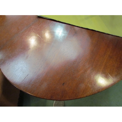 4176 - A pair of Arts & Crafts mahogany lamp tables the chamfered edge oval tops over tapering square colum... 