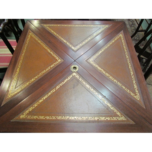 4187 - A reproduction envelope table with leather inserts, pedestal base with reeded legs, paw feet to cast... 