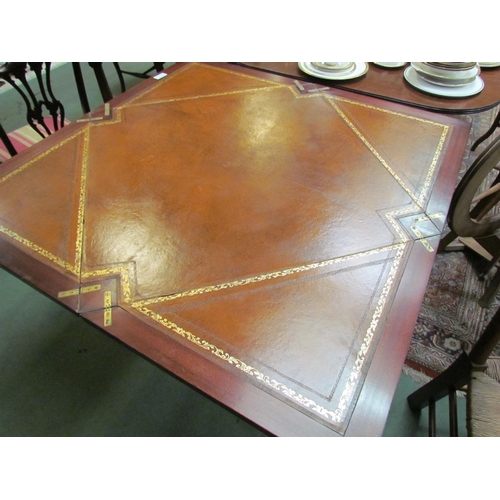 4187 - A reproduction envelope table with leather inserts, pedestal base with reeded legs, paw feet to cast... 