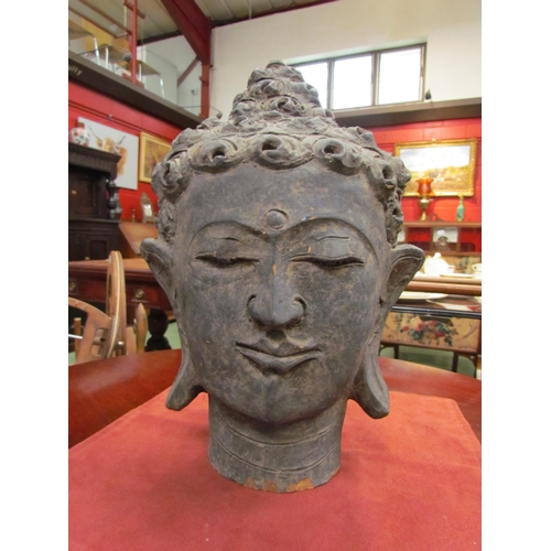 4193 - WITHDRAWN:An earthenware Buddhas head, 33cm high