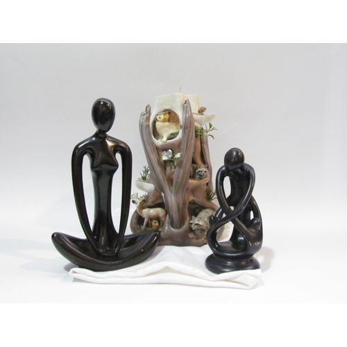 4263 - Two modern stylized figures including Yoga pose, together with a candle display in the form of a tre... 