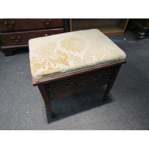 1085 - A late Victorian walnut dressing table stool with upholstered top over fretwork sides, square taperi... 