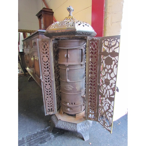 1001 - A Victorian enamelled cast iron floor standing heater with decorative floral detailing, lid with fin... 