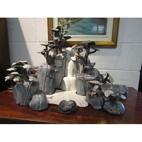 1017 - A Tessa Fuchs studio pottery sculpture of a rocky landscape with trees and waterfall, 47cm high, a/f... 