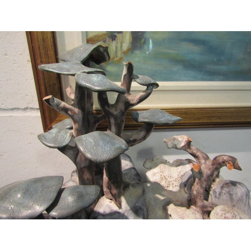 1017 - A Tessa Fuchs studio pottery sculpture of a rocky landscape with trees and waterfall, 47cm high, a/f... 