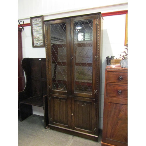 1019 - A Jaycee Furniture Ltd. oak Old Charm style lead glazed china display cabinet, the two glazed doors ... 