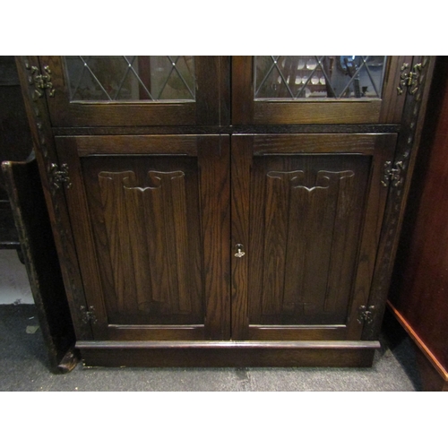 1019 - A Jaycee Furniture Ltd. oak Old Charm style lead glazed china display cabinet, the two glazed doors ... 