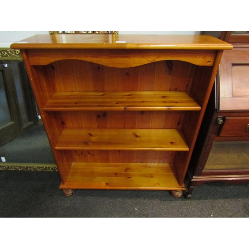 1026 - A modern pine bookcase, 98cm high x 83cm wide x 23cm deep, together with a light oak nest of three t... 