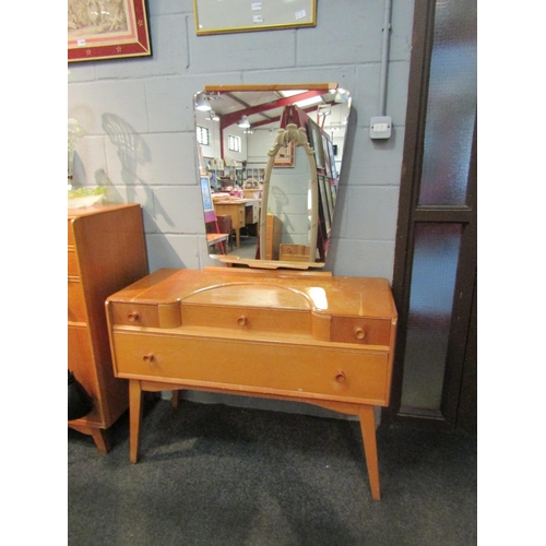 1029 - A 1960s Austinsuite light oak dressing table with four drawers, mirror back and splayed legs, 155cm ... 