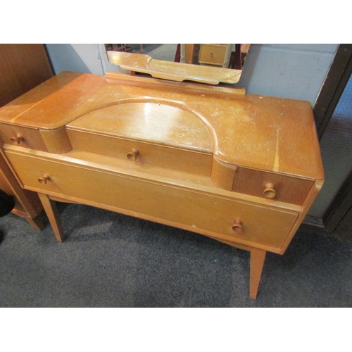 1029 - A 1960s Austinsuite light oak dressing table with four drawers, mirror back and splayed legs, 155cm ... 