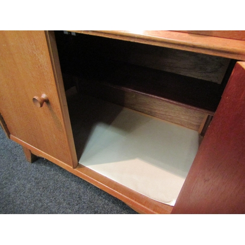 1033 - A 1960's Austinsuite light oak cupboard, three drawers over two cupboard doors, splayed legs, 107cm ... 