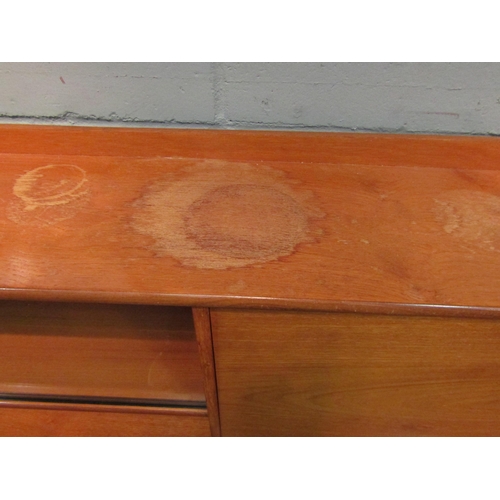 1036 - A retro 1960’s teak sideboard with glazed display section, drop-flap, four drawers and two cupboard ... 