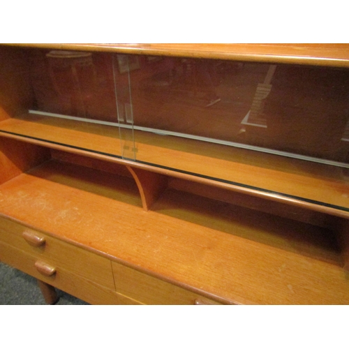 1036 - A retro 1960’s teak sideboard with glazed display section, drop-flap, four drawers and two cupboard ... 