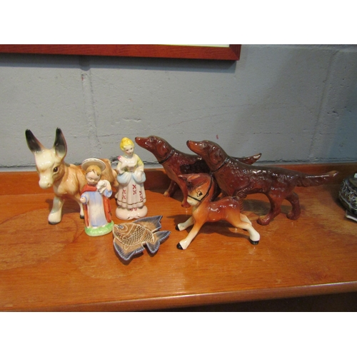 1040 - A quantity of ceramic figures including dogs, a Wade fish design pin dish and figures. Some a/f (7) ... 