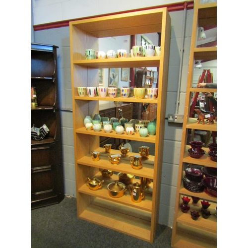 1042 - A light oak mirror back display shelf, 198cm high x 85cm wide x 24cm deep   (R) £25