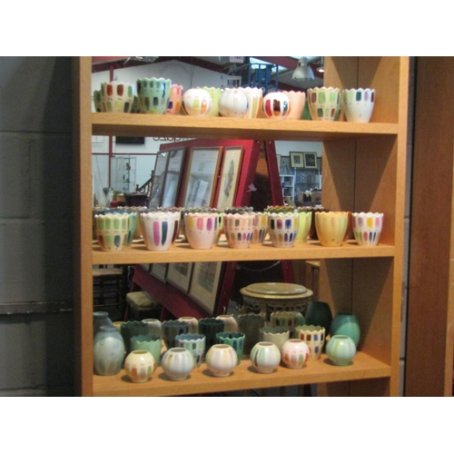 1043 - A quantity of studio pottery pots decorated in numbered glazes in different colours/shades, some a/f... 