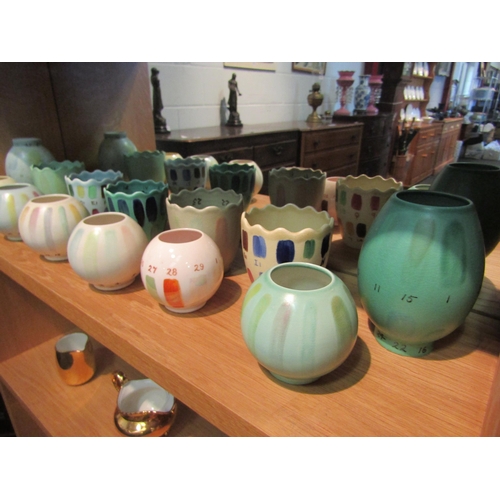 1043 - A quantity of studio pottery pots decorated in numbered glazes in different colours/shades, some a/f... 