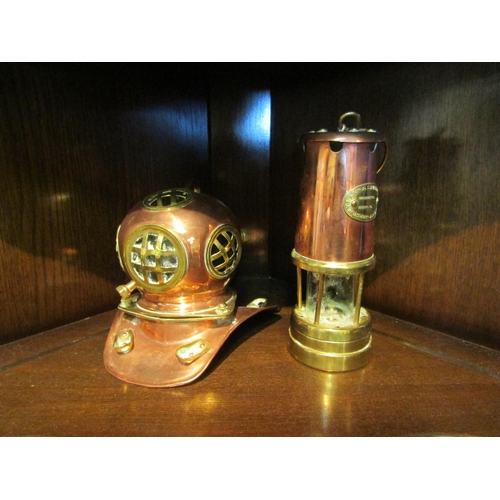 1046 - A copper Hockley Lamps & Limelight company miners lamp and a brass and copper diving helmet ornament... 