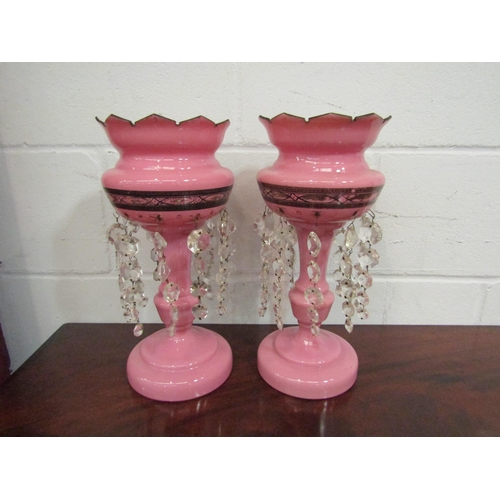 1061 - A pair of pink glass lustres, 36cm high