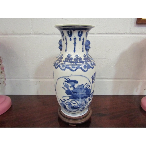 1062 - A modern Chinese blue and white vase with decoration of ducks among foliage, on wooden base, 31cm ta... 