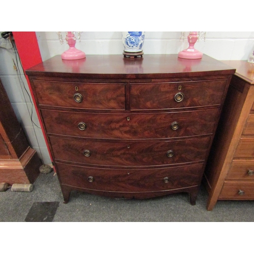 1064 - A George III flame mahogany bow front chest of two short over three graduating long drawers with oak... 