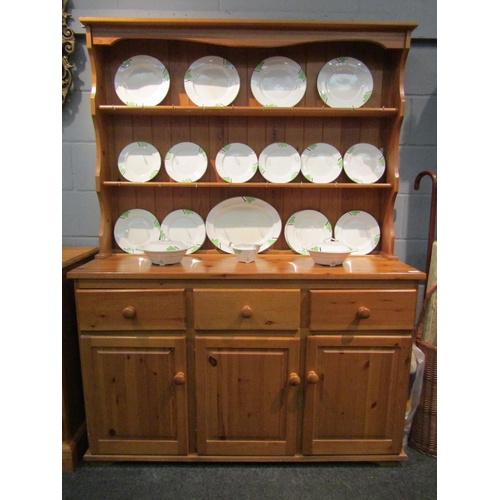 1068 - A modern pine dresser, the plate rack top over three drawers and three cupboards, 183cm high x 136cm... 