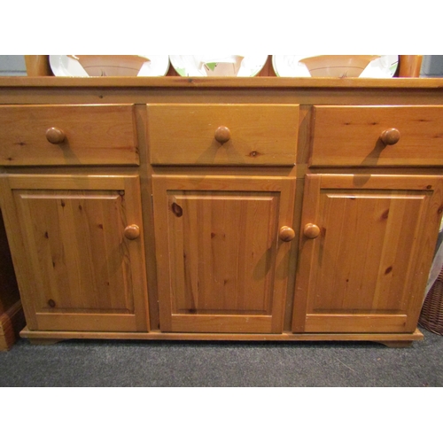 1068 - A modern pine dresser, the plate rack top over three drawers and three cupboards, 183cm high x 136cm... 