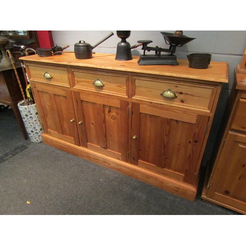 1072 - A pine dresser base with three drawers over three door cupboard, 87cm high x 152cm wide x 45cm deep ... 