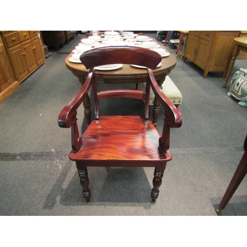 1076 - A Victorian style mahogany armchair with carved decoration   (R) £35