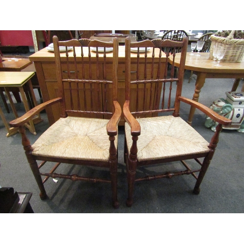 1082 - A pair of Liverpool / fan back oak armchairs, the carved top rail over a spindle back rest and sea g... 