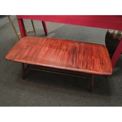 1086 - A 1960s Ercol elm coffee table, slatted undertier, heavily varnished to top, 35cm high x 105cm long ... 