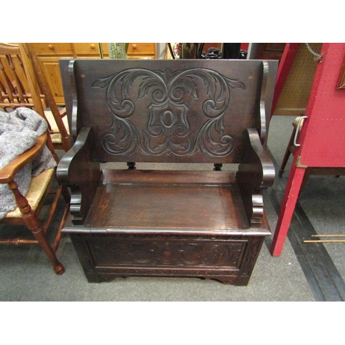 1101 - A late Victorian carved oak box seat hall settle the pegged hinged table top on shaped slab supports... 