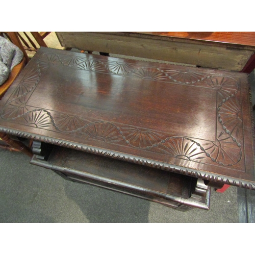 1101 - A late Victorian carved oak box seat hall settle the pegged hinged table top on shaped slab supports... 