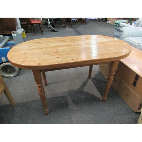 1106 - A modern pine kitchen table, rounded top, turned legs, 75cm high x 136cm long x 75cm wide   (E) £10-... 